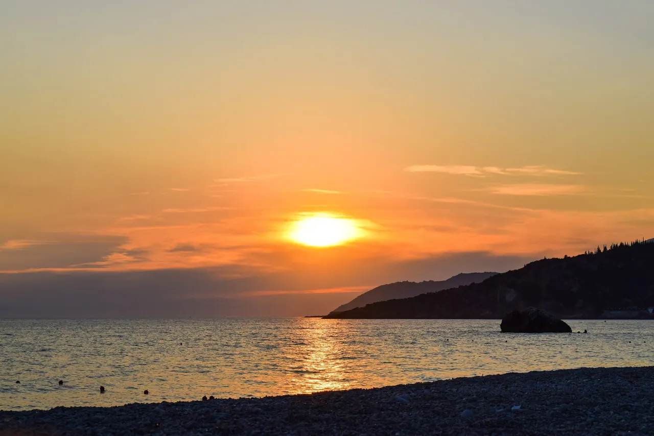 Sunset over the pebbles of Livadhi Beach