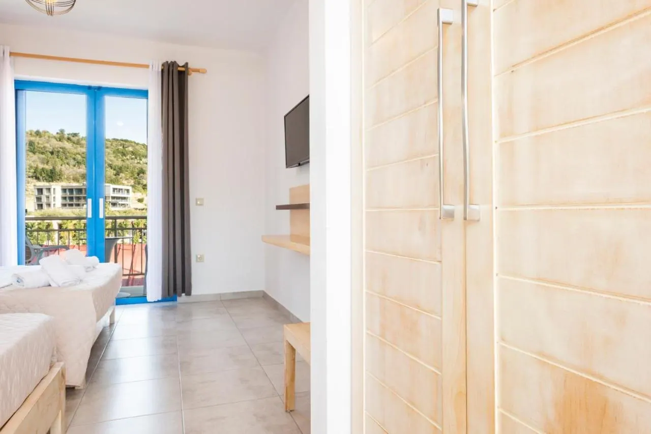 Spacious triple room at Blue Horizon with three beds and a balcony