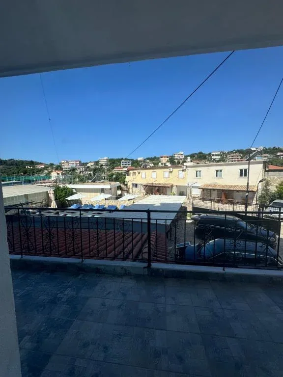 The view from a balcony at Hotel Frida over the fenced pitch and the neighbouring roofs to the ridge