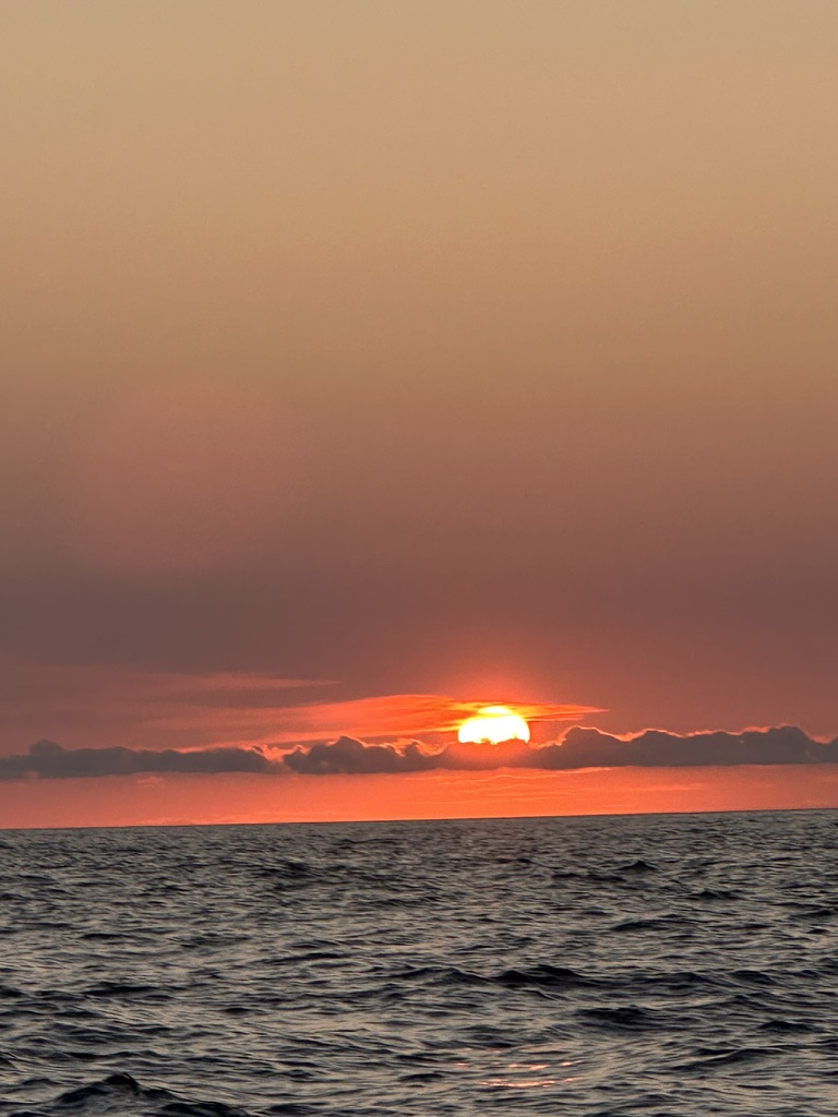 Sunset over Potam Beach where Lui Potam seafood restaurant sits on the pebbles