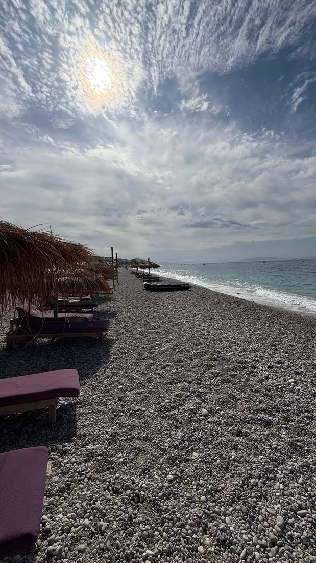 Drymades Beach with white pebbles and blue Ionian waters near Dhermi village