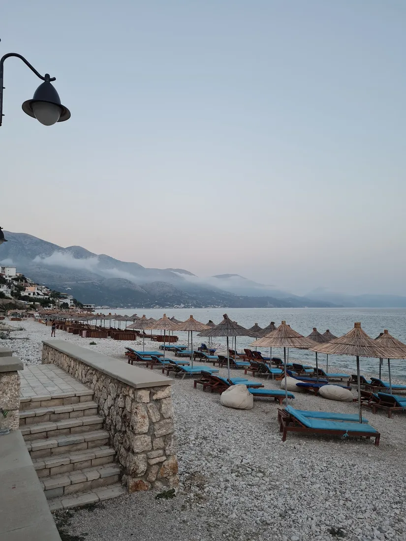 Qeparo Beach stone promenade with old-style lanterns