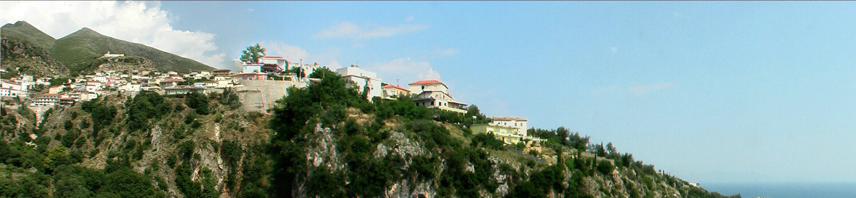 Dhermi village below and the hilltop where Panagia Drymadon monastery overlooks the Ionian coast