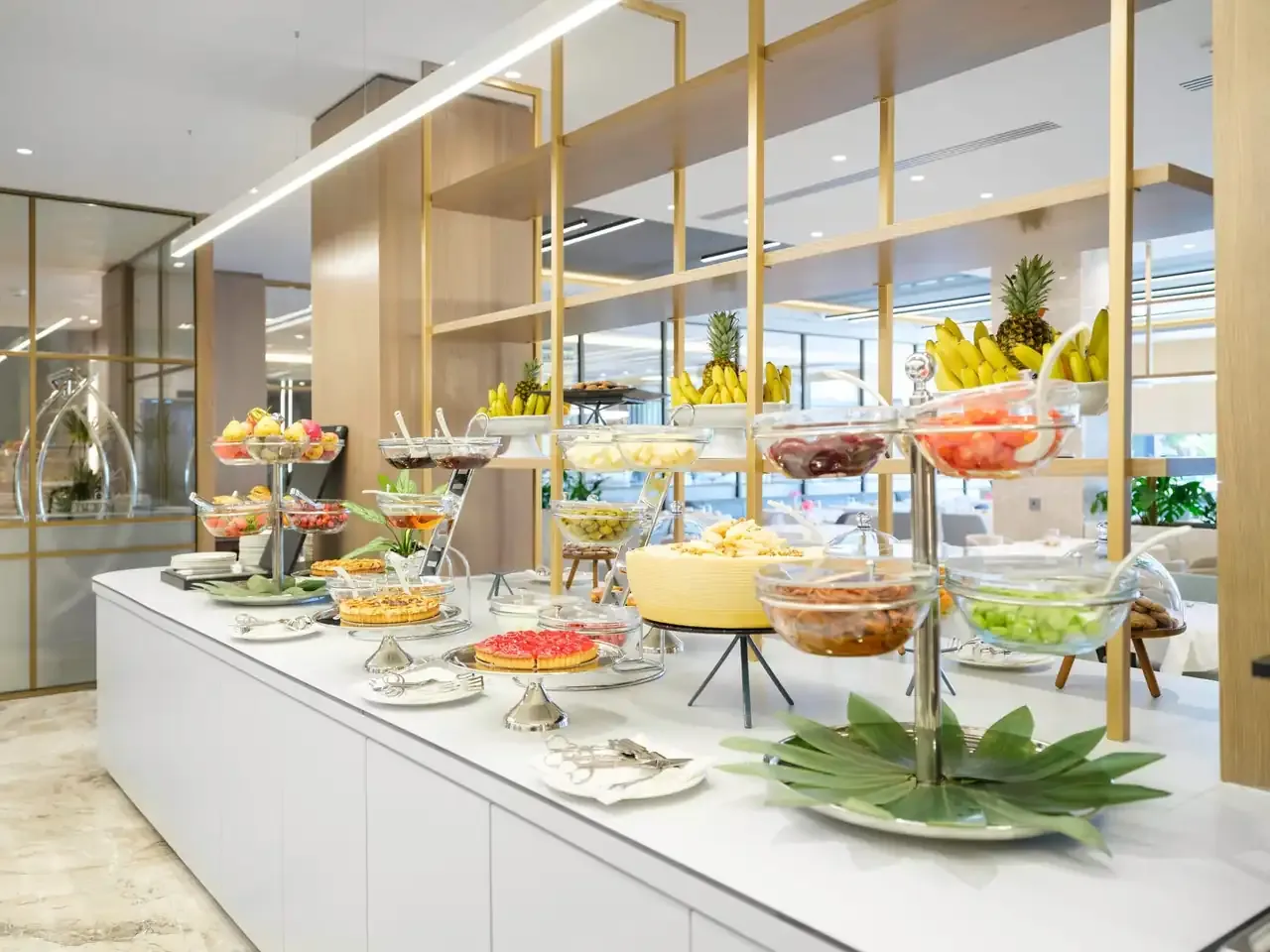 The breakfast buffet counters at Prado laid with fruit, pastries and cold plates