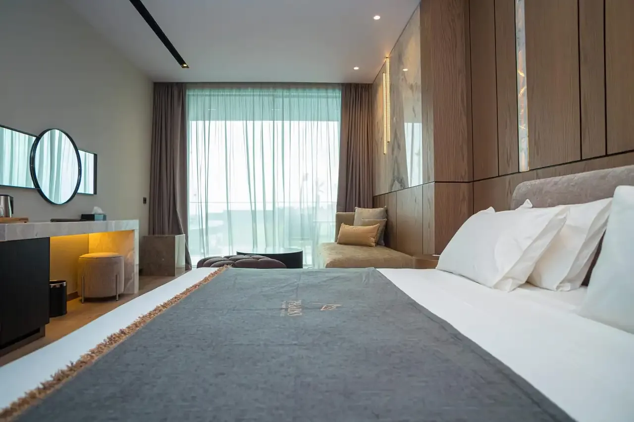 The bed in a Junior Suite with the Prado mark stitched into the runner