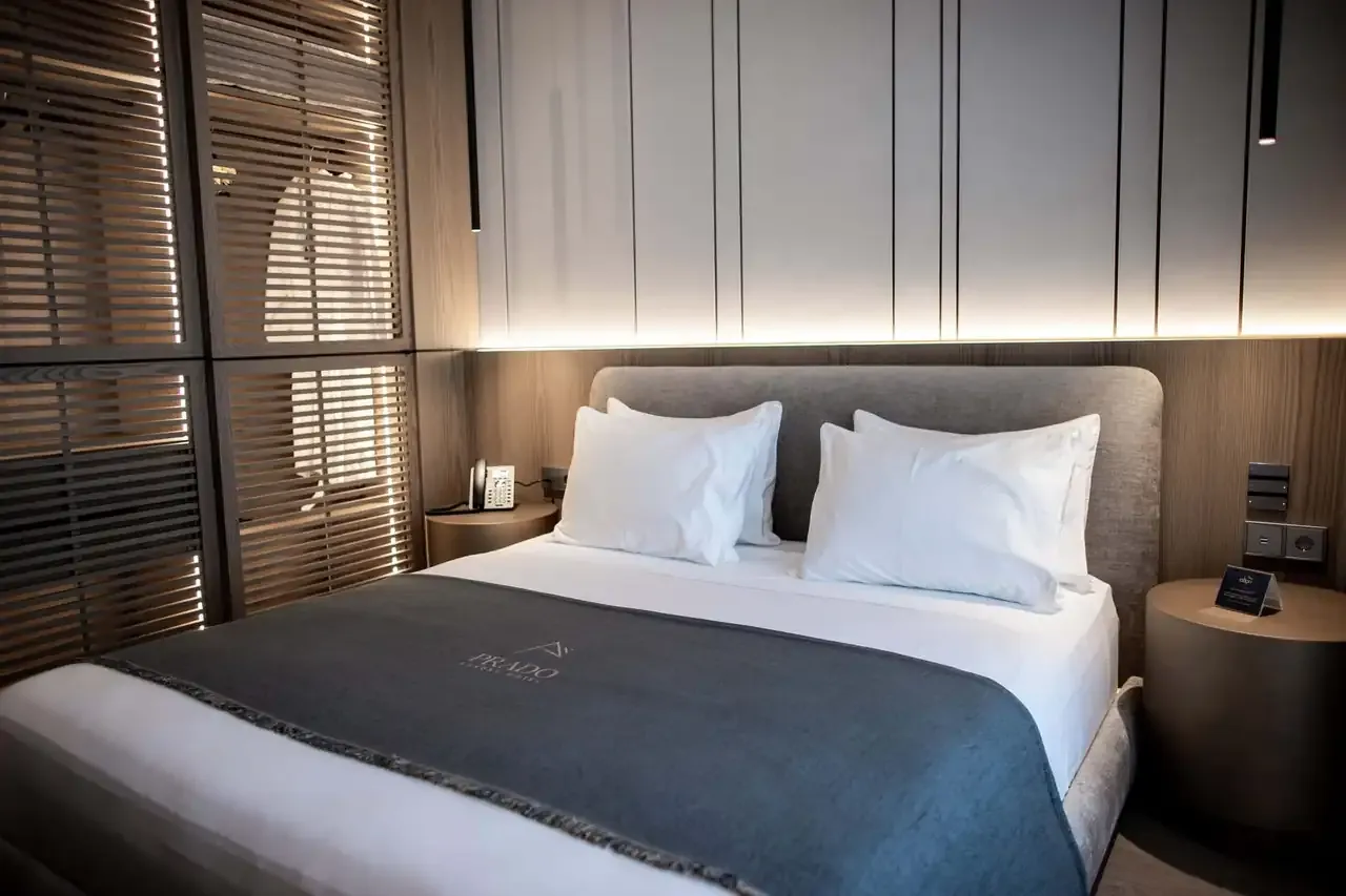 A super king bed against oak panelling in a Standard Room at Prado