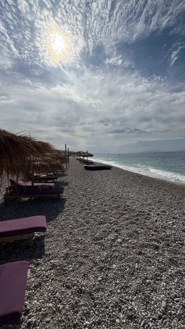 Drymades Beach with white pebbles and blue Ionian waters near Dhermi village