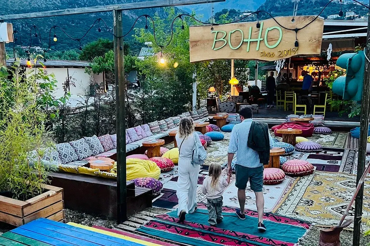 BOHO Livadh beach bar's boho-chic lounge with floor cushions, rugs and a fishing-net canopy by the sea