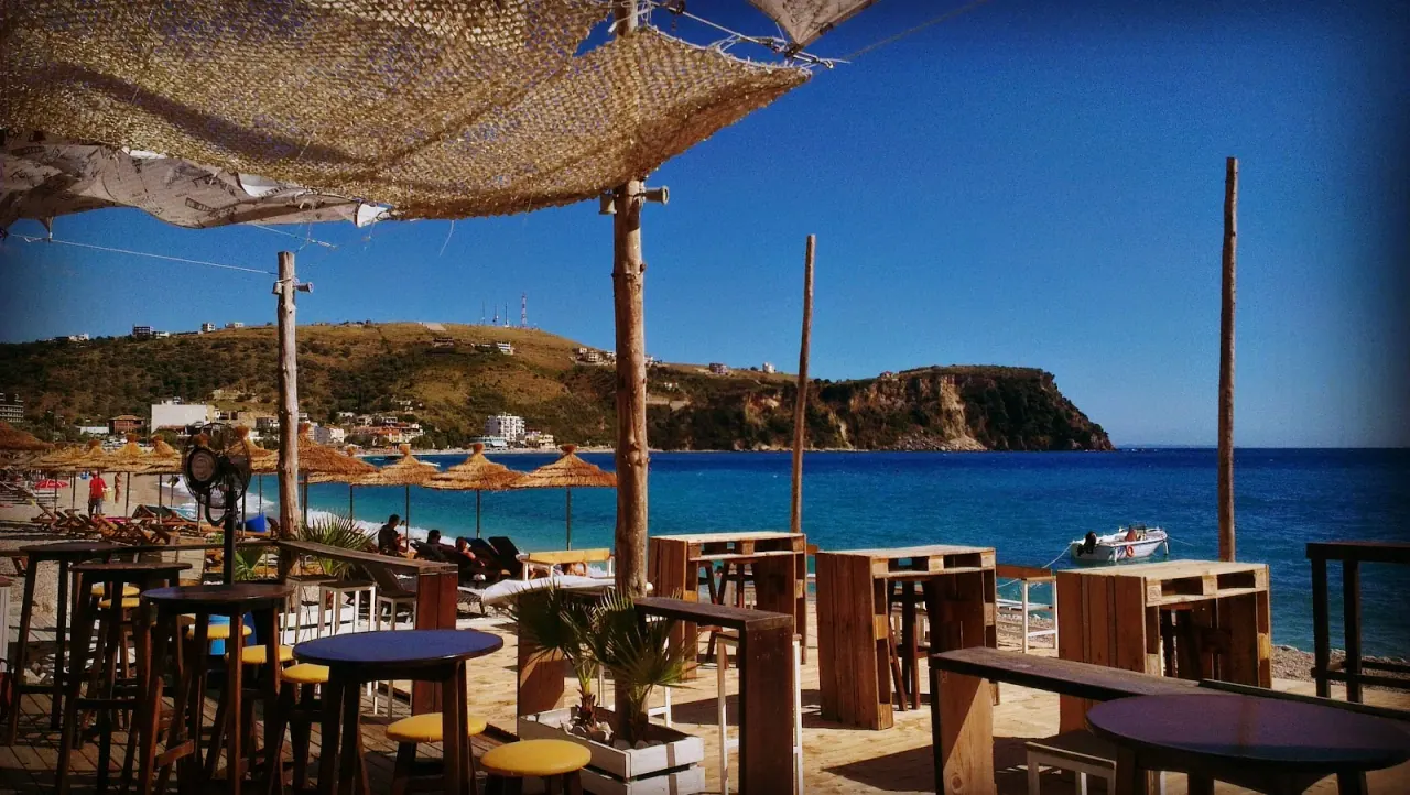 Rescue @ The Beach bar's covered seating with high tables on Himara beach overlooking the bay