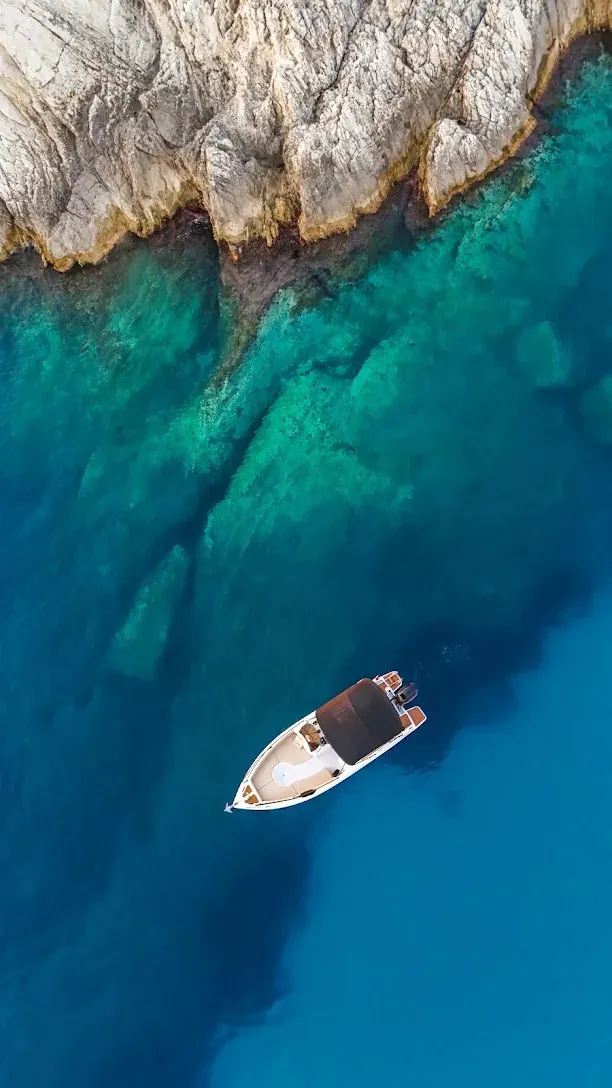 Himara Golden Boat Tours boat cruising the Himara coastline, Albanian Riviera