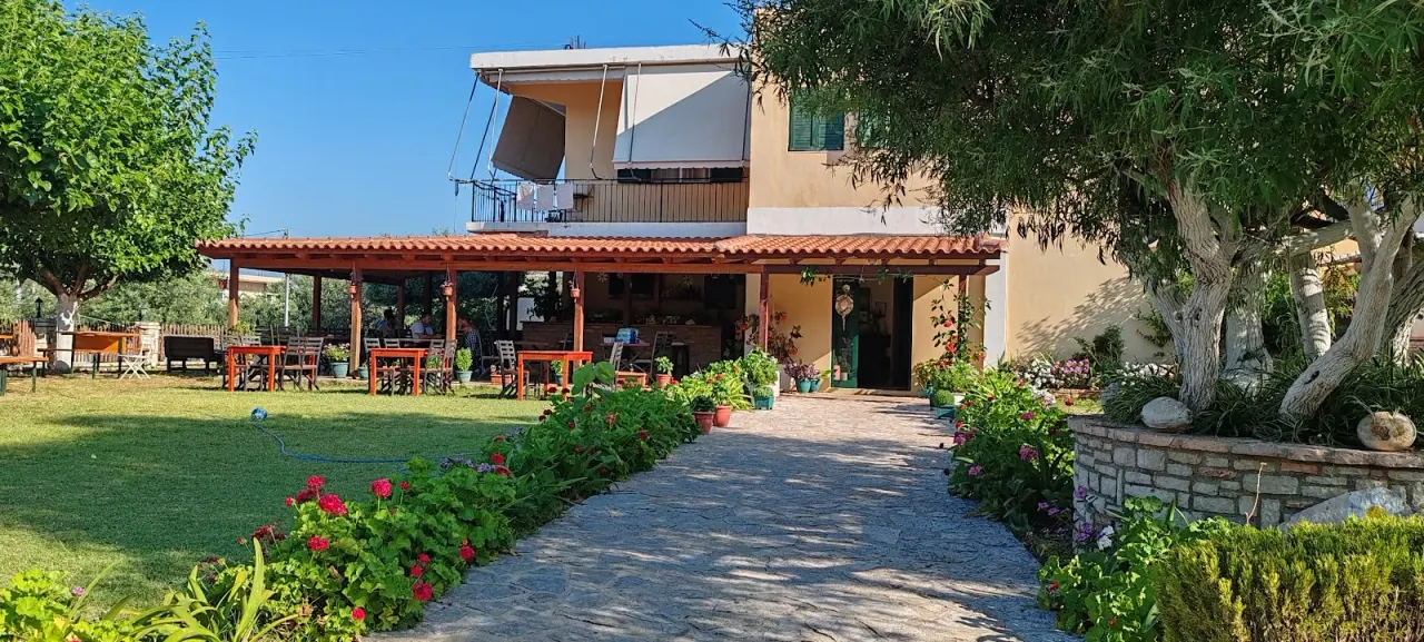 Covered terrace and garden of the farmhouse at Agrotourism Himara