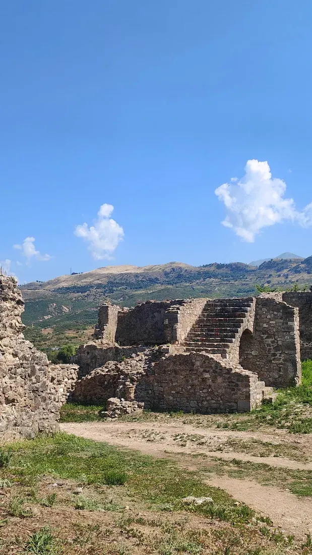 Stone ruins of the monastic complex at Mesopotam with hills behind