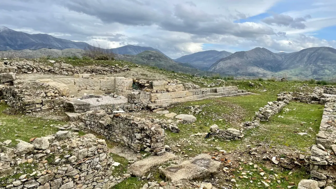 Hilltop fortification ruins of ancient Phoenice (Finiq) with mountains behind