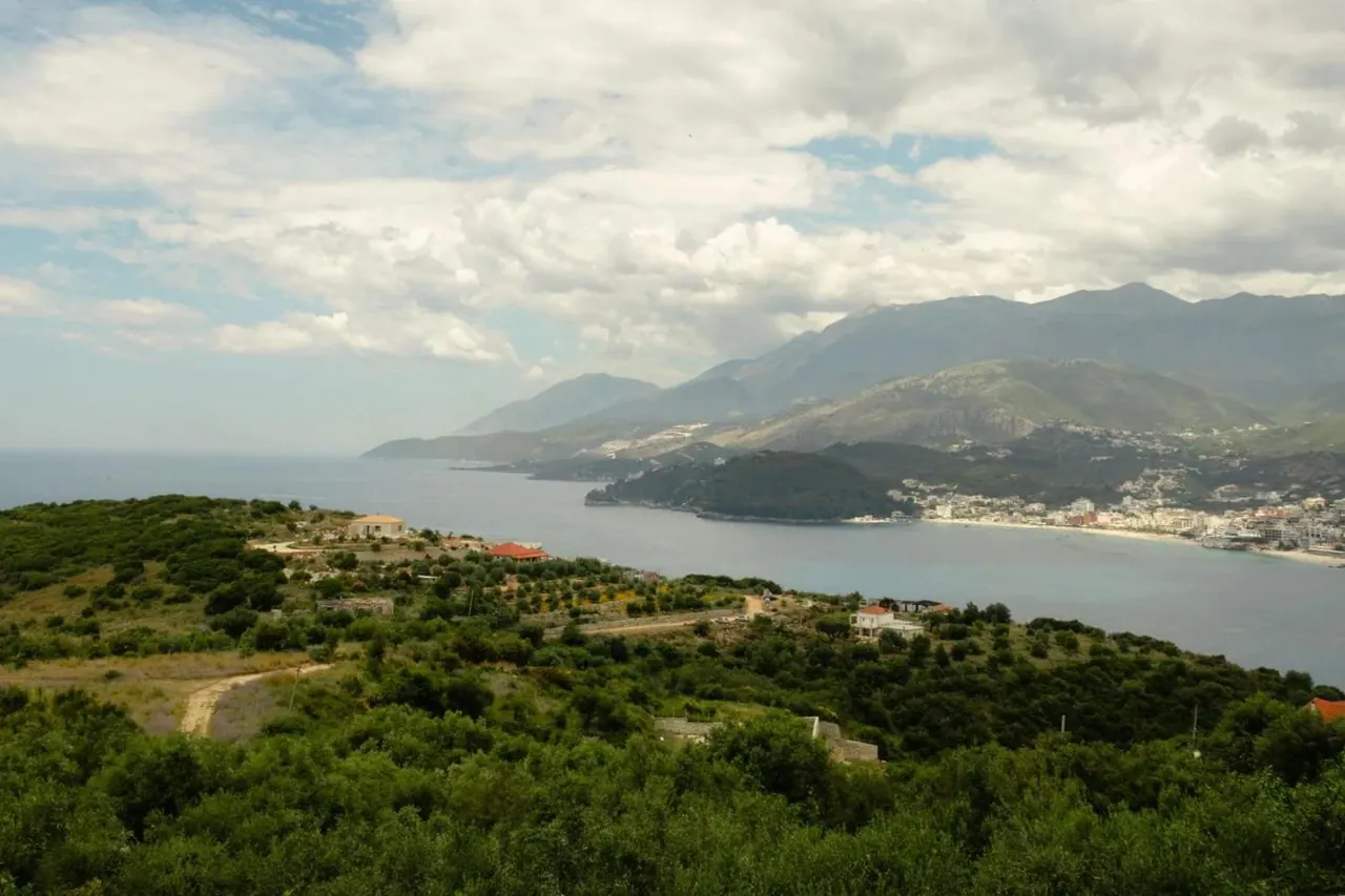 A daytime panorama from the property over the wooded headland, Himarë bay and the coastal mountains