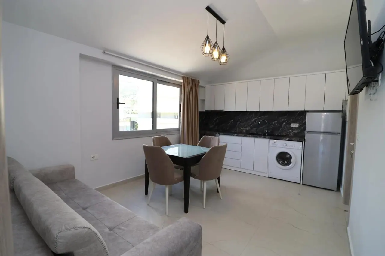 Apartment kitchen and dining area with a window onto the mountains
