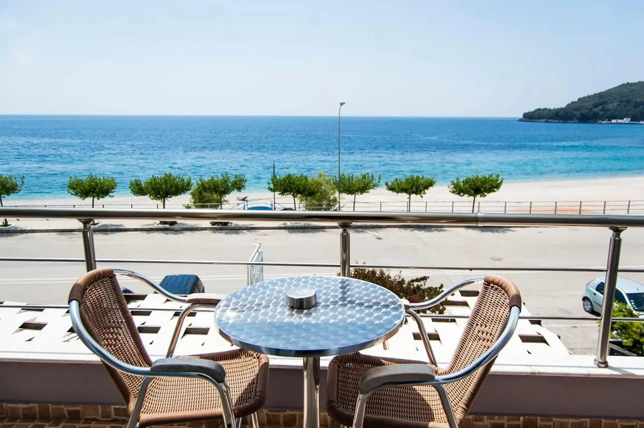 A balcony table looking across the coast road to the beach and open sea