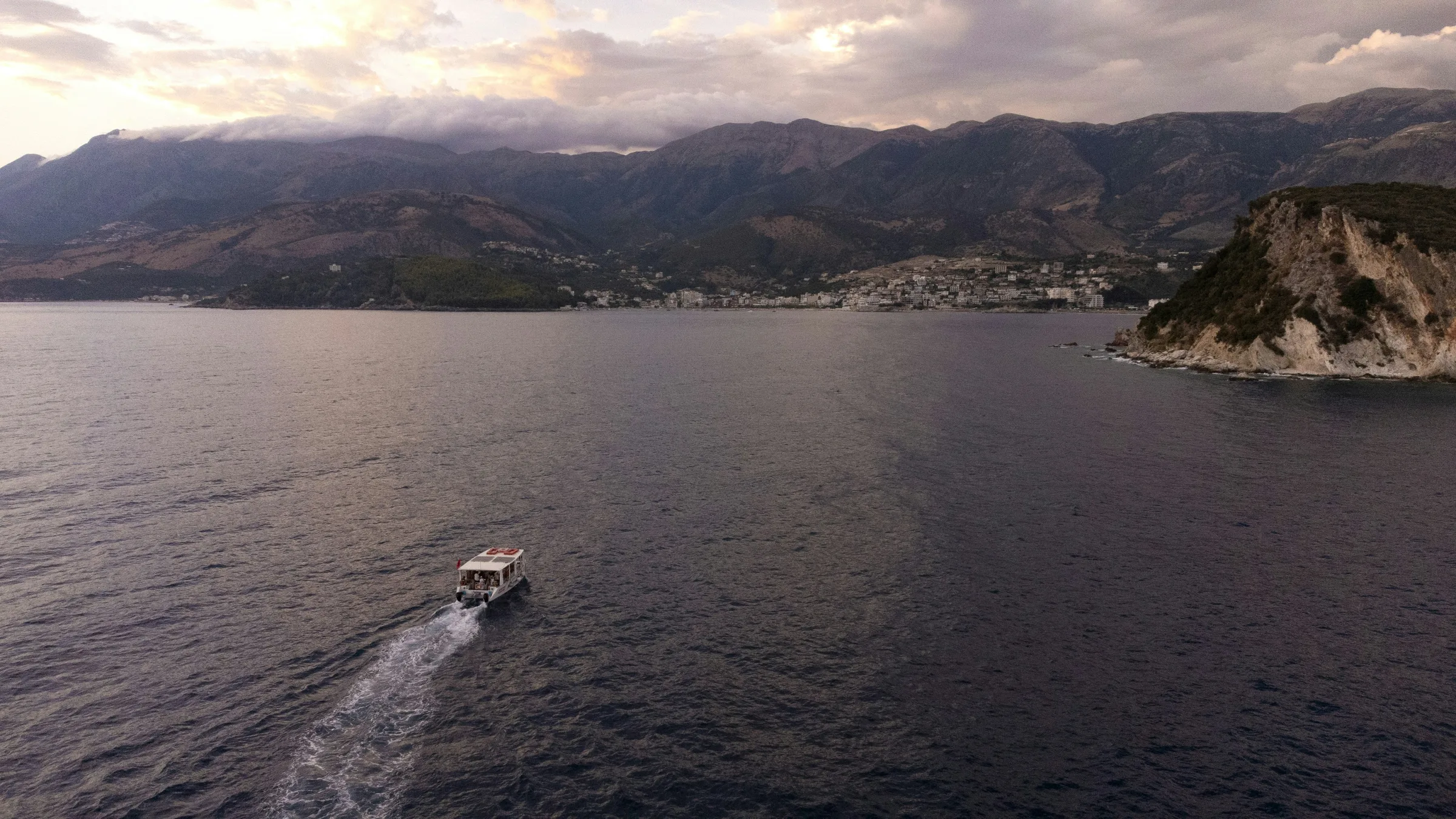 Albanian Riviera coastal road with hairpin turns above the Ionian Sea, May 2026
