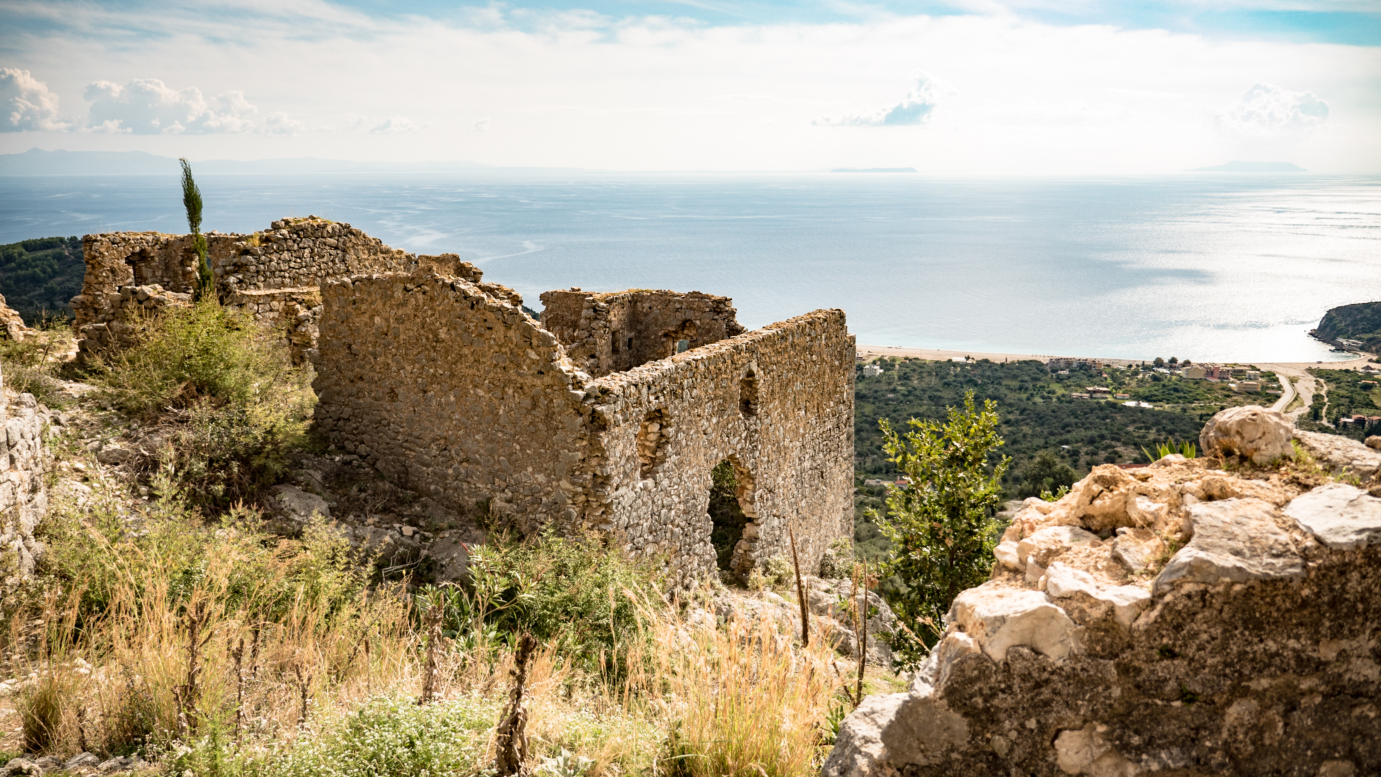 Aerial old-town and coastline view representing free sightseeing in Himara