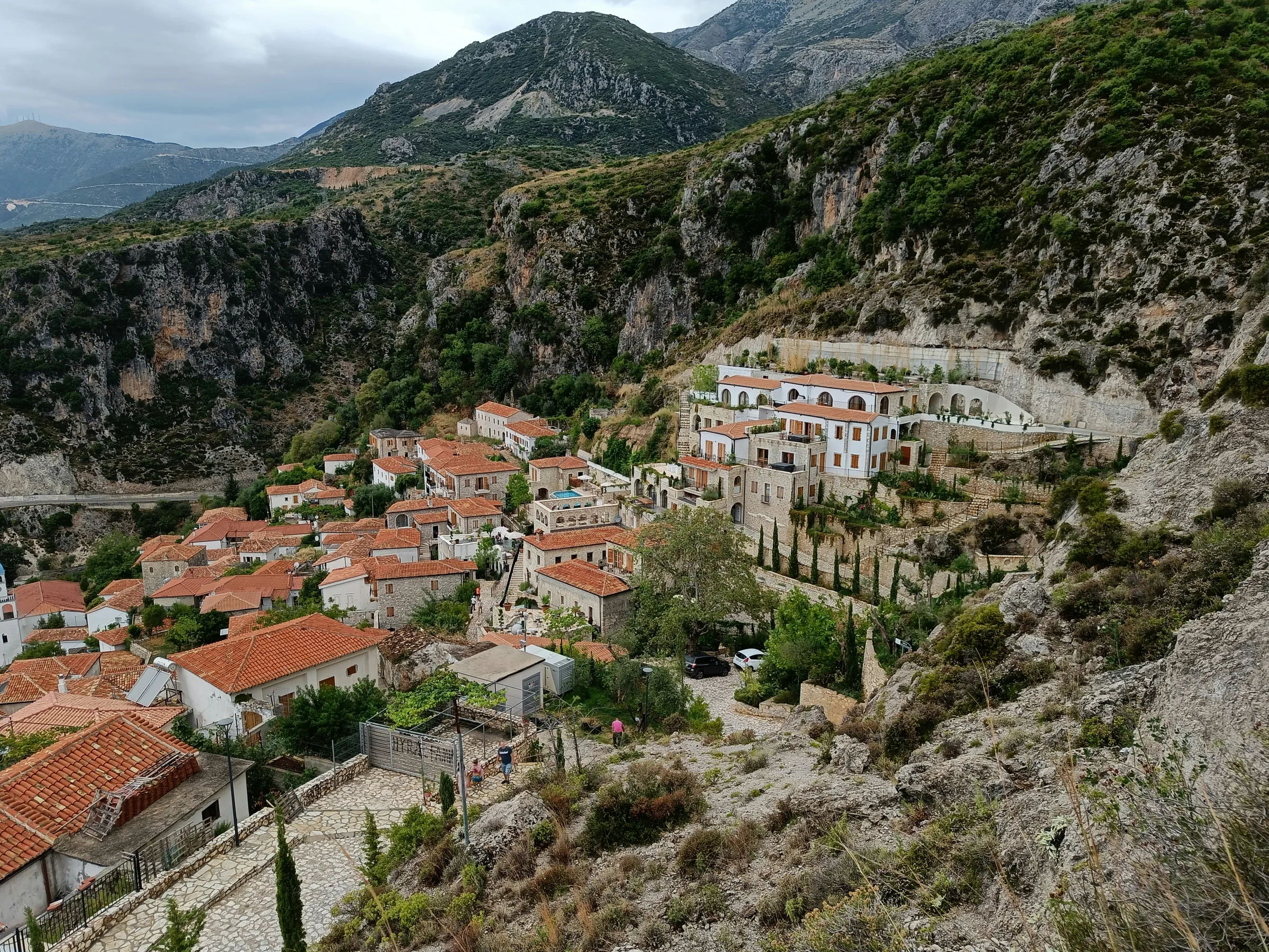 Coastal view of Livadhi Beach area near Himara with the village and road access visible from above