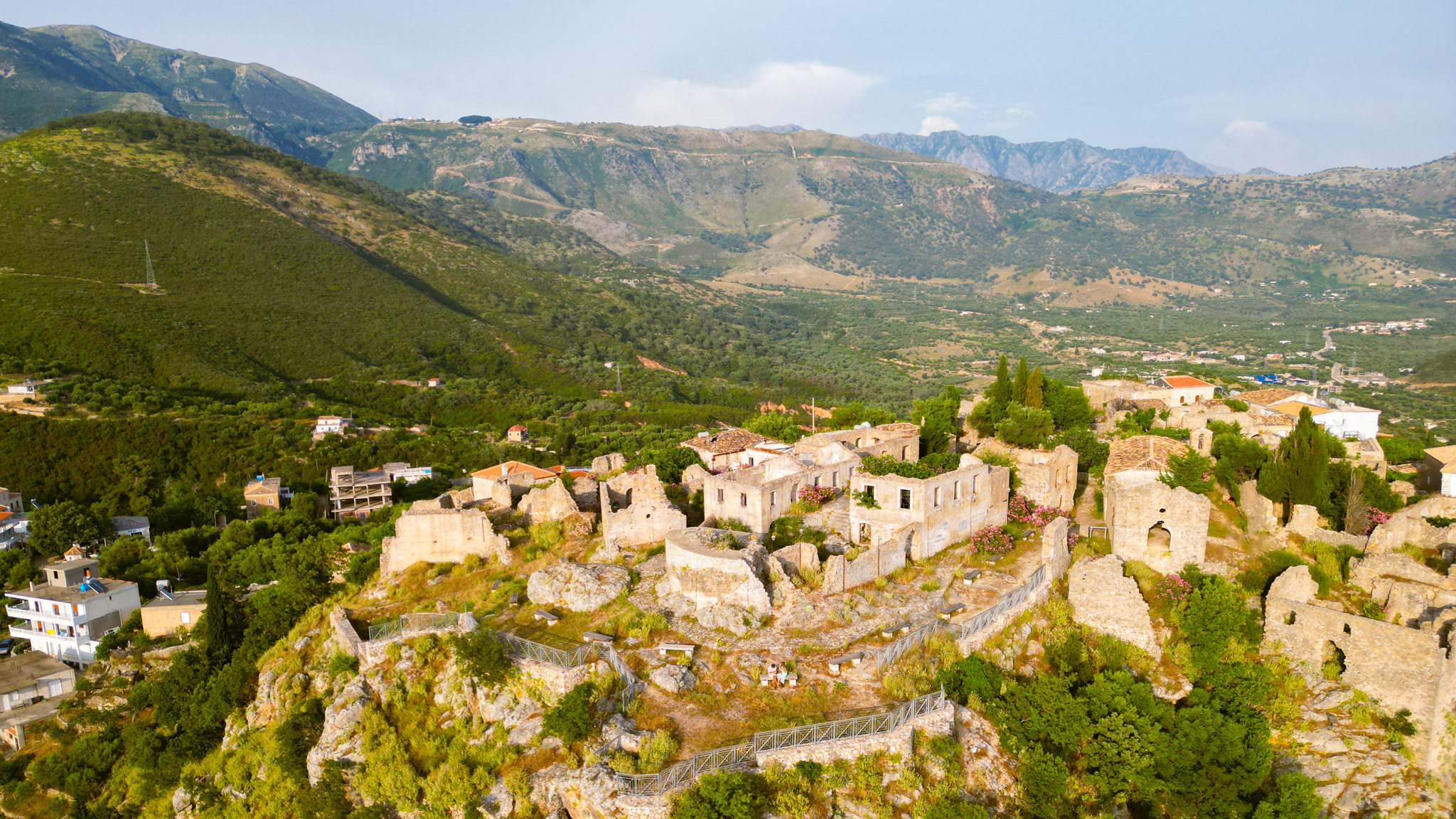 Aerial view of Himara castle ruins on a headland above the Ionian Sea