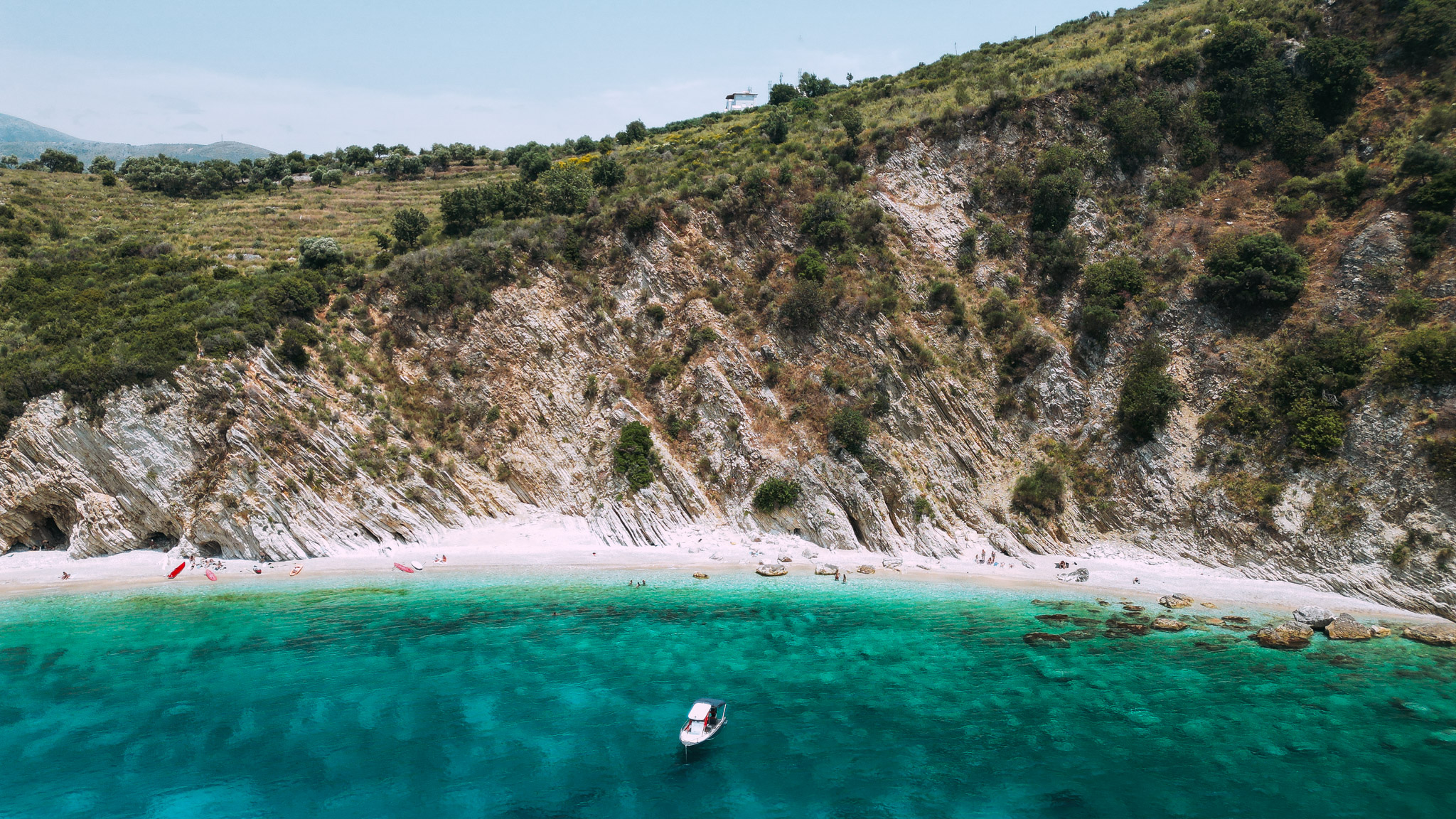 Aerial view of Himara town coastline with multiple beaches and turquoise water