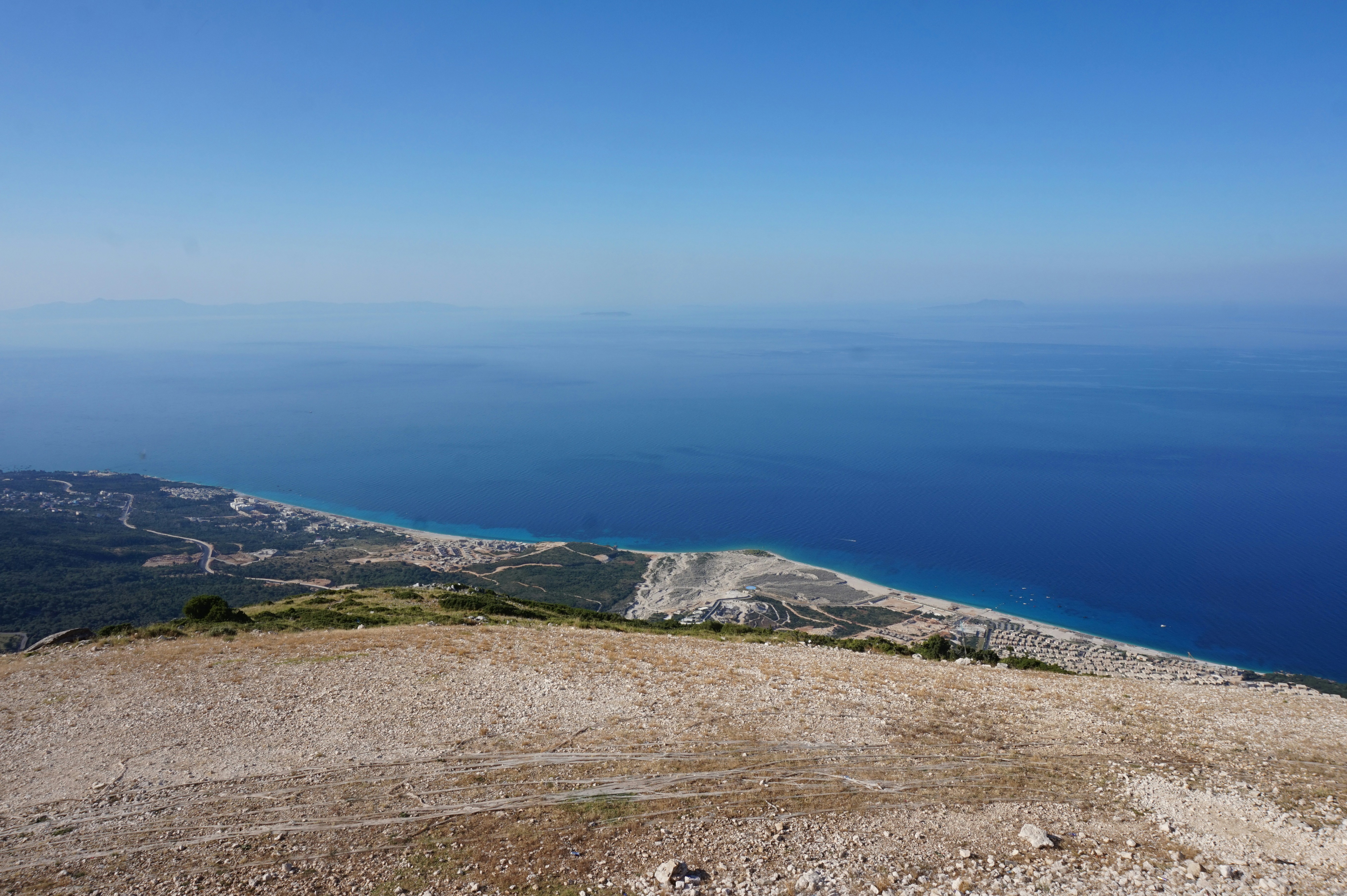 Split view comparison of Albanian Riviera coastal landscape