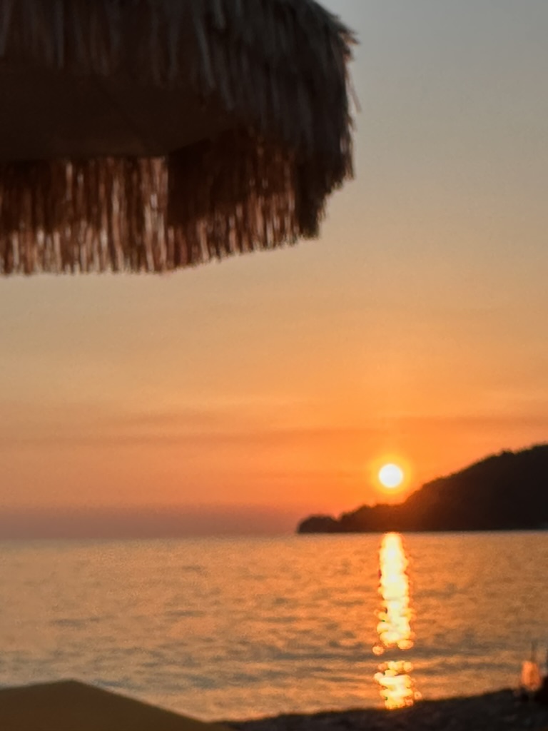 Sunset over Potam Beach near Rapo's Resort Hotel in Himara on the Albanian Riviera