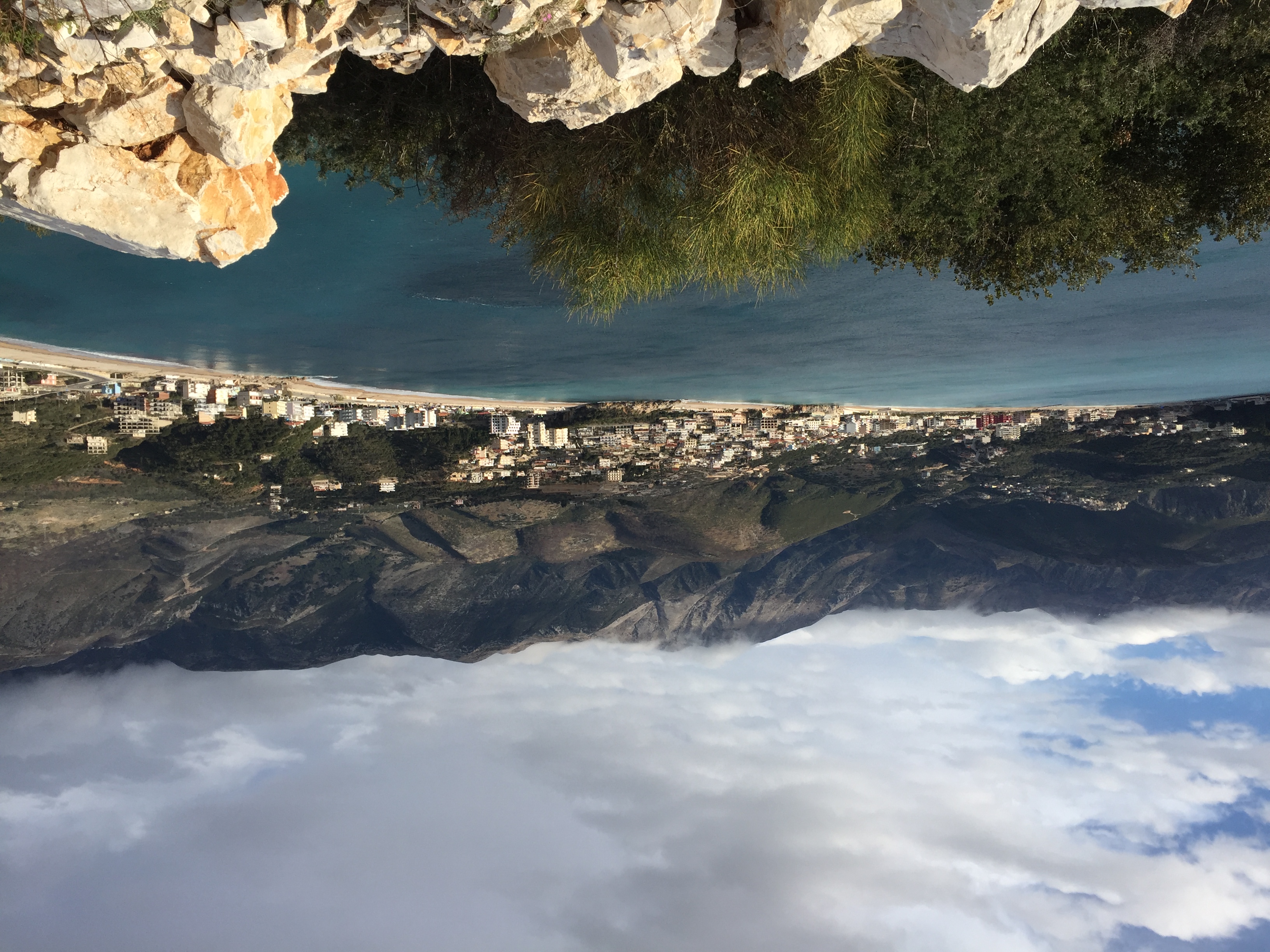 Sfageio Beach with turquoise shallow waters beside the Himara pier