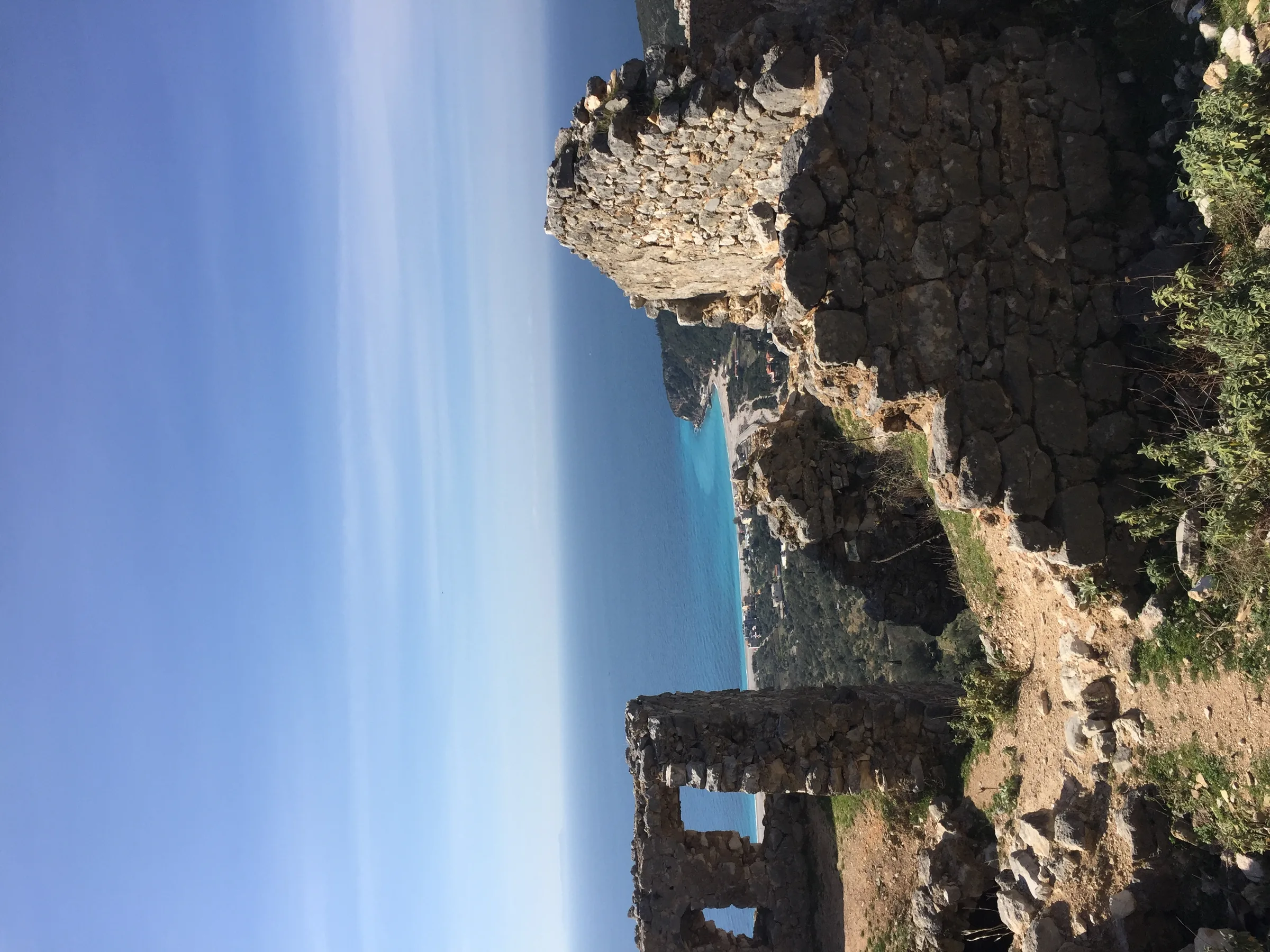 Stone walls and Byzantine church ruins at Himara Castle overlooking the coast
