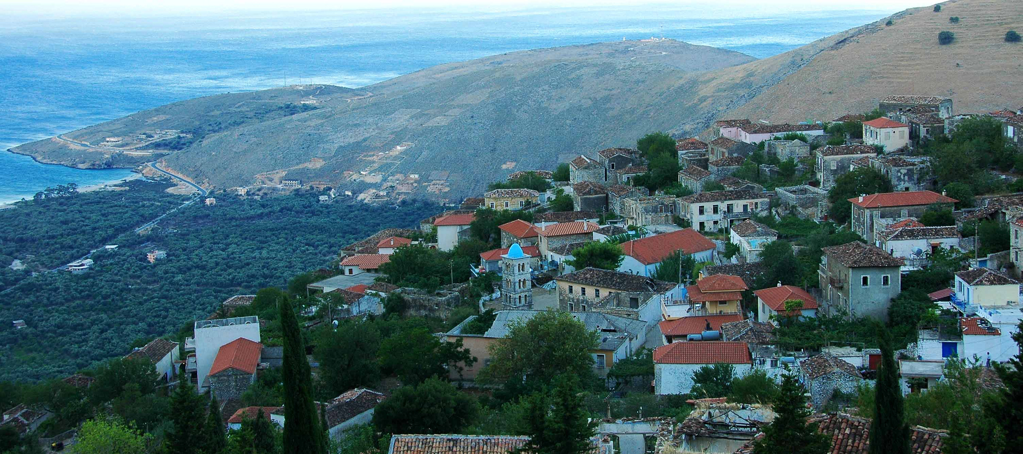 Stone houses of Old Qeparo village perched on a hillside above the Albanian Riviera