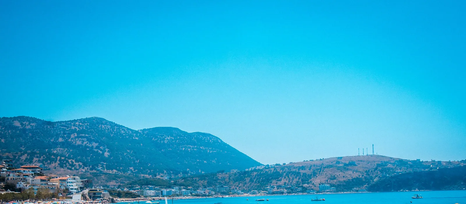 Spile bay at Himarë — the water, the town beach and the ridge behind the town the restaurant stands in, not the restaurant