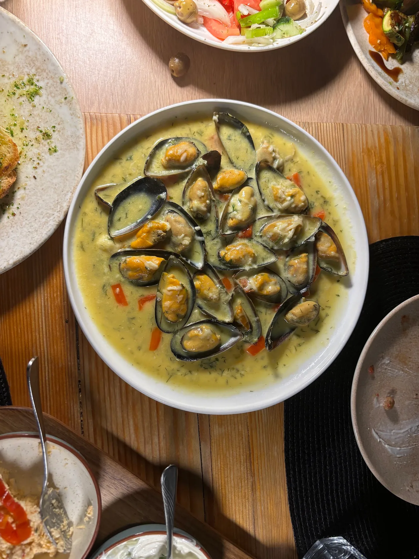 Bowl of mussels on the half shell in a dill broth at Fig & Olive, Himarë