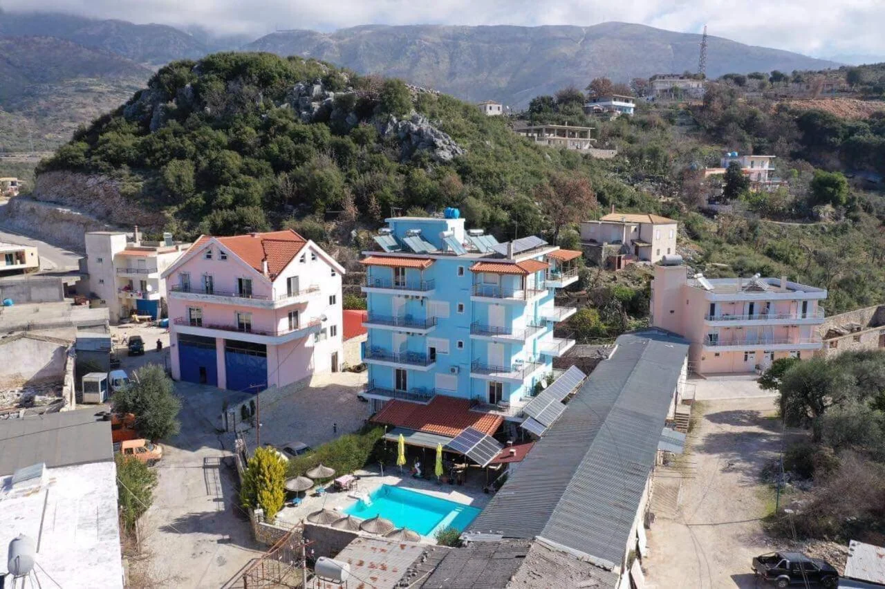 Hotel Frida from the air: the pool with its slide and straw parasols on the level below the building