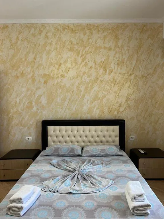 Standard Quadruple Room: the bed square-on, with a nightstand either side