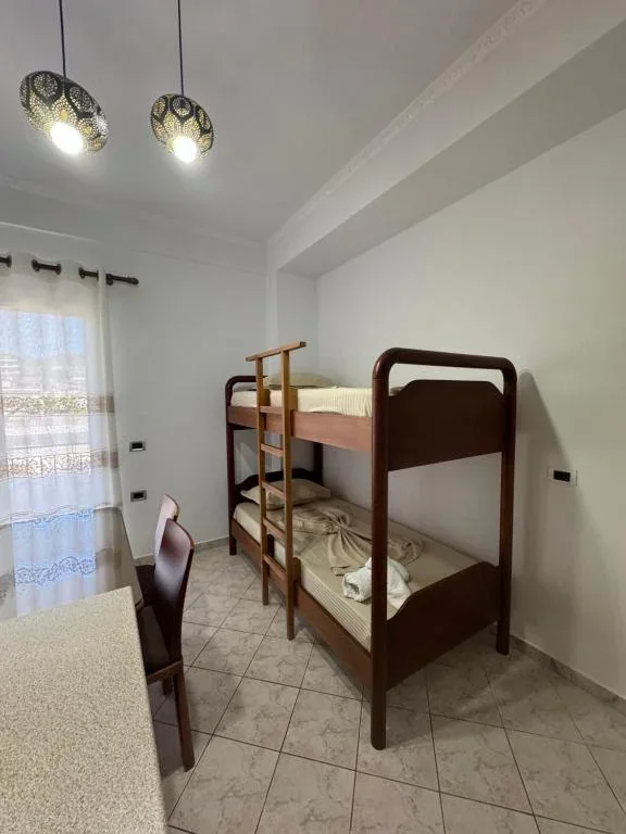Family Suite: a timber bunk bed against the wall, with a table and chair by the window