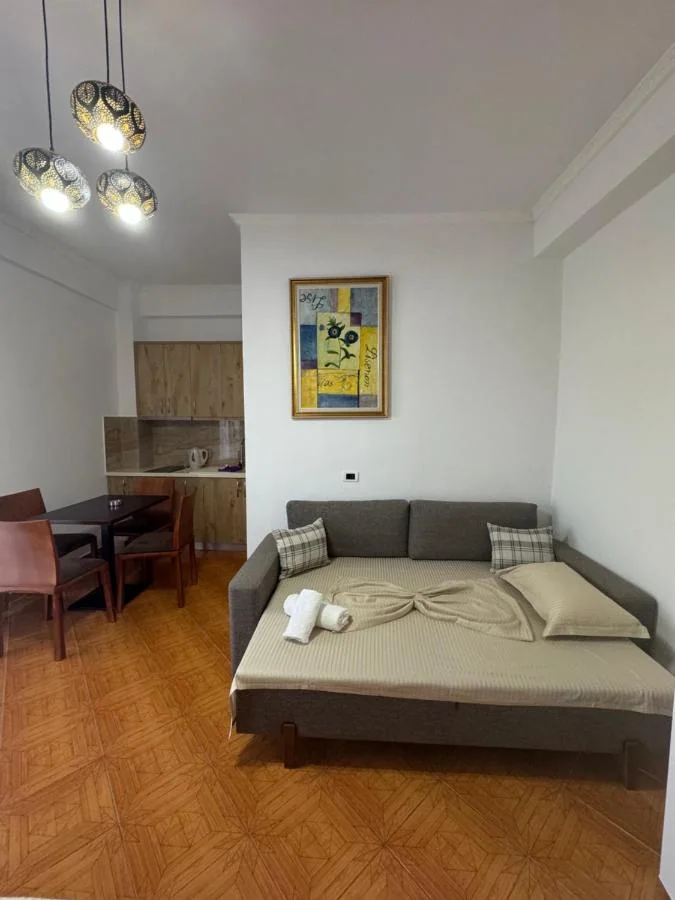 Triple Room: the sofa, the dining table and the kitchen units with a kettle