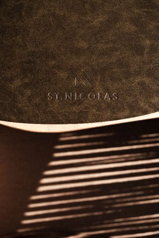 The hotel's embossed menu folder in raking light