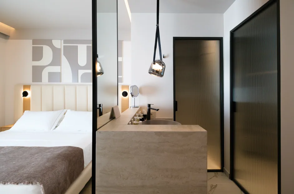 The marble bathroom of a Double Room with Sea View, with a walk-in shower