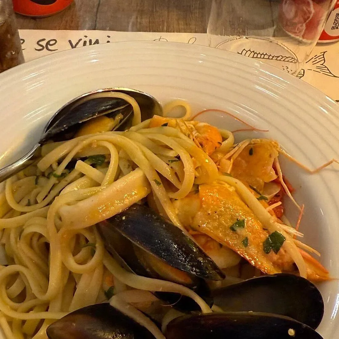 Linguine with mussels, a prawn and rings of squid, close