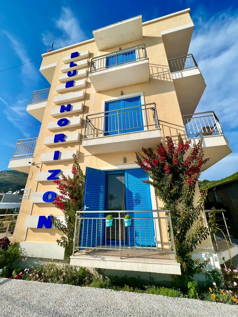 The Blue Horizon building with blue shutters and bougainvillea