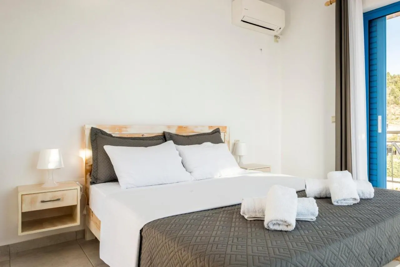 Bright double room at Blue Horizon with wooden bed and balcony