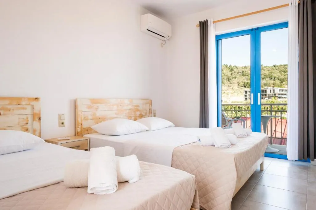 Spacious triple room at Blue Horizon with three beds and a balcony