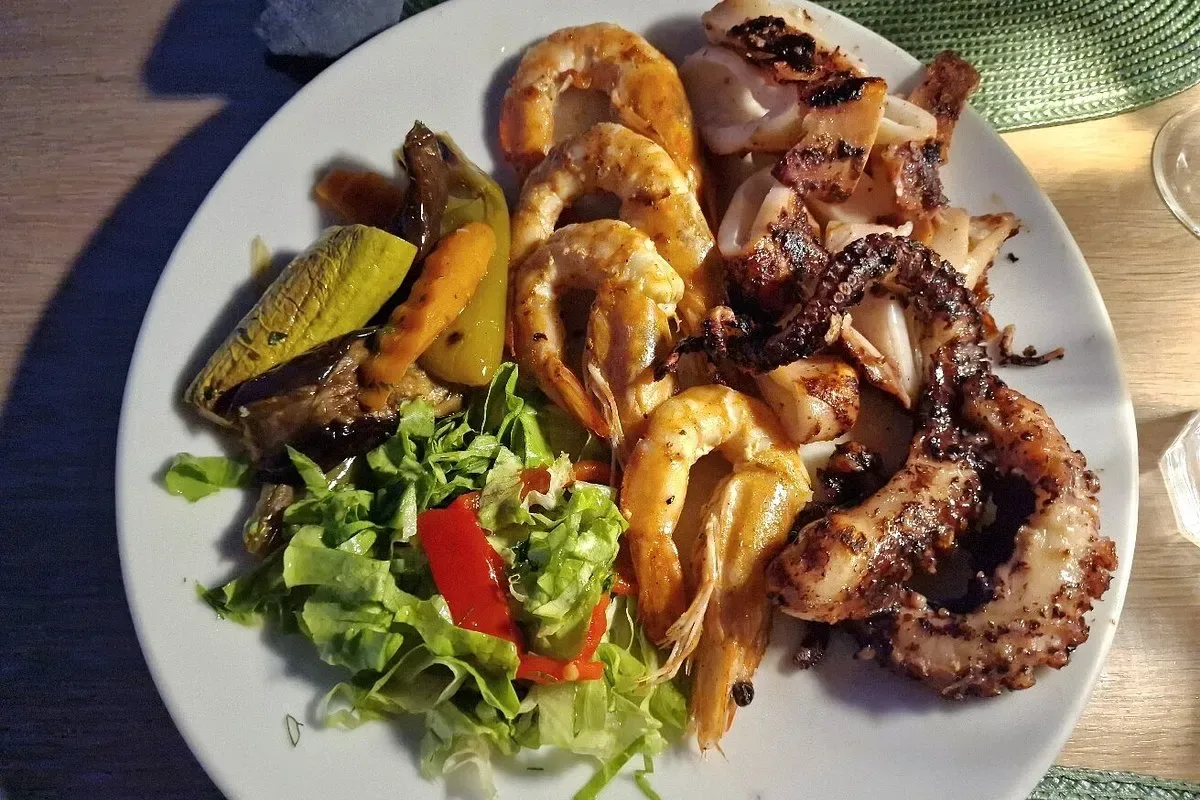 Mixed grilled seafood of prawns, calamari and octopus with salad at Fig & Olive, Himarë