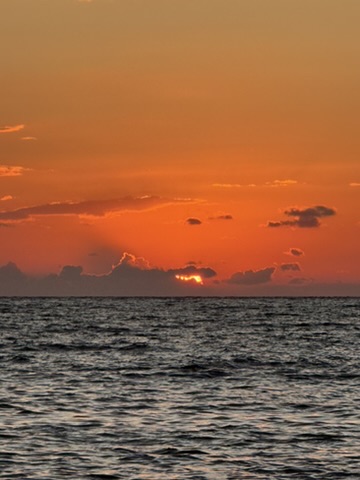 Sunset view over Spile Beach on the Albanian Riviera with calm Ionian waters