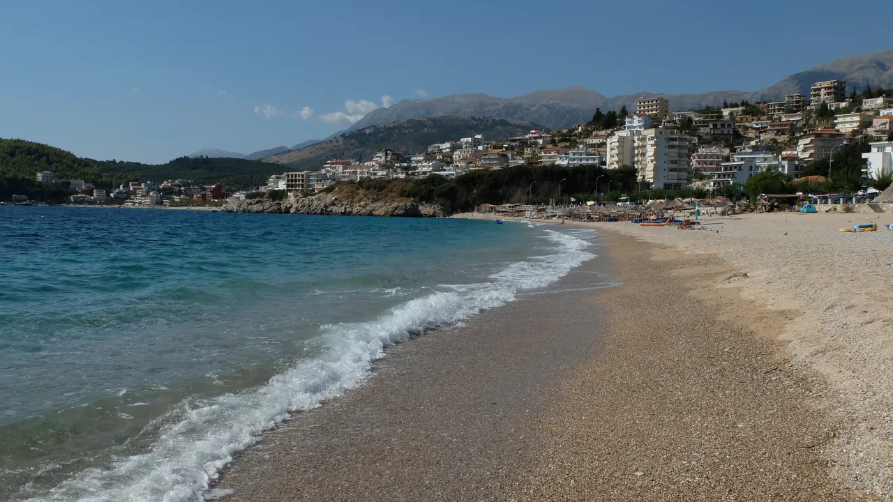 Apartment buildings and houses climbing the hillside above Himara's coastline, where residents actually live