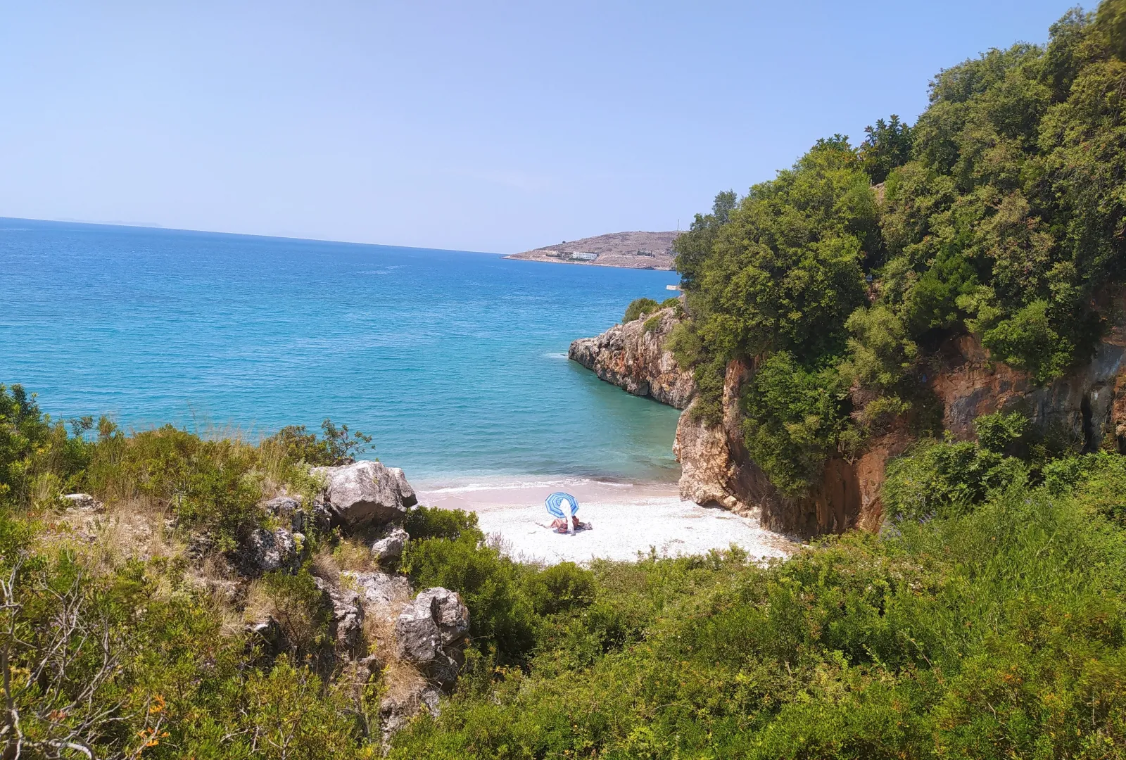 Aerial view of the isolated cove and pebble shoreline at Qeparo on the Albanian Riviera