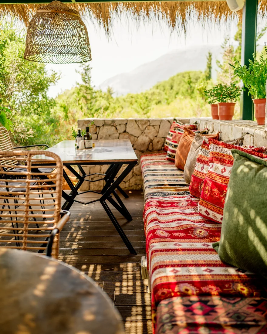 Boho terrace with kilim cushions and a mountain view at Morsi Drymades on Drymades Beach