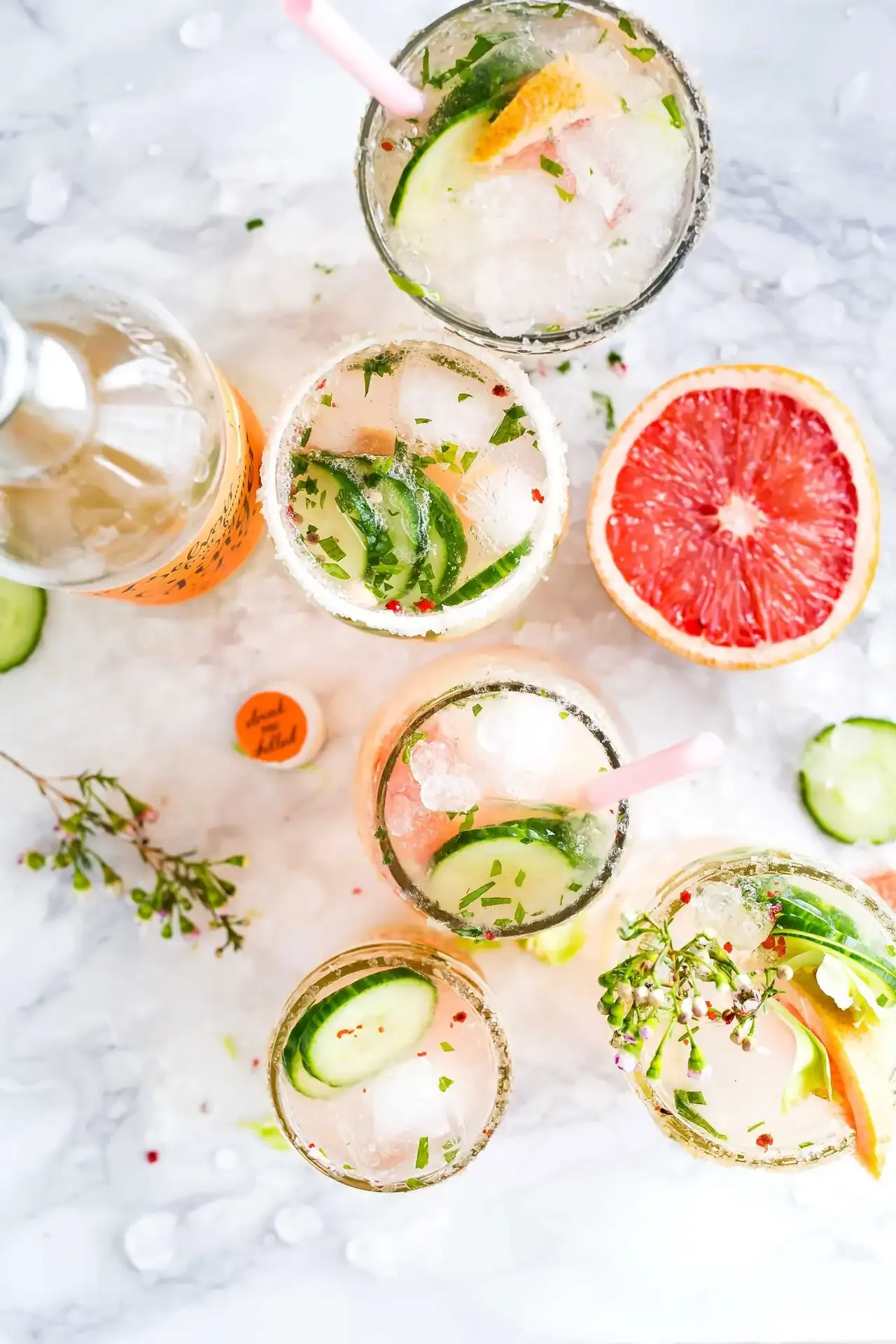 Cocktails on ice with grapefruit, cucumber and herbs at the pool bar
