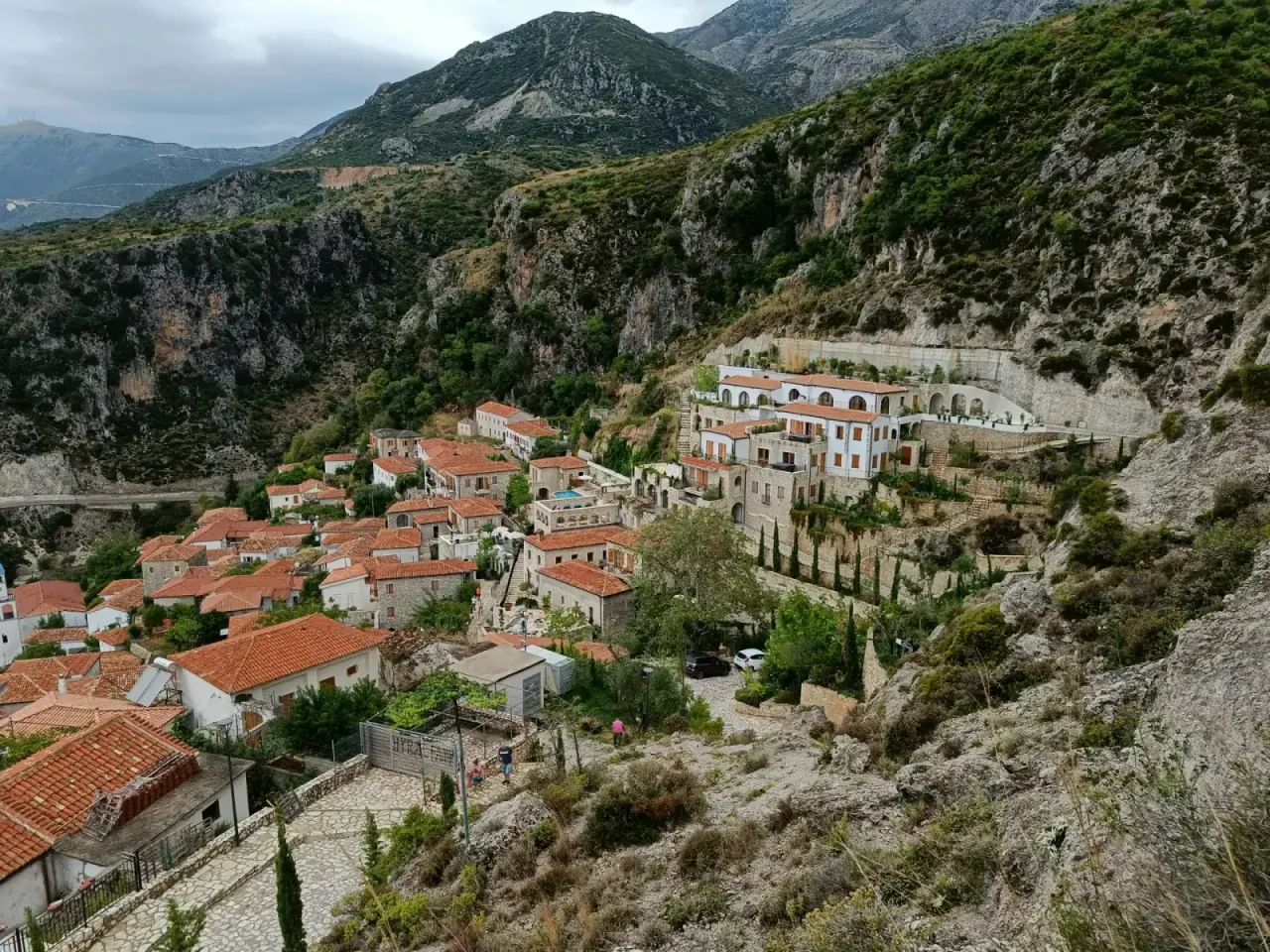 View of Livadhi Beach area with tree-lined coastline providing natural shade near Himara
