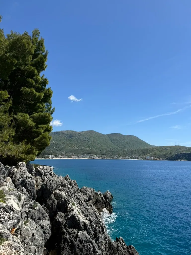 Sunset view along a coastal road on the Albanian Riviera heading toward the Kakavia border